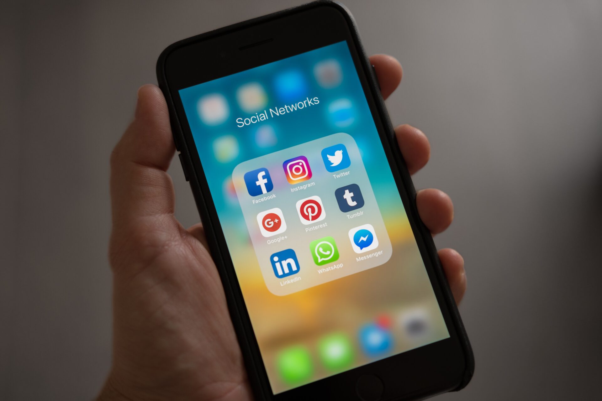 pexels-eva-elijas-6956316 Person Holding Iphone Showing Social Networks Folder